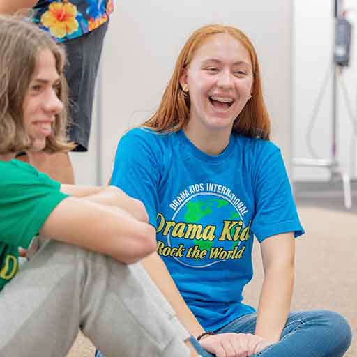 Drama students sitting laughing