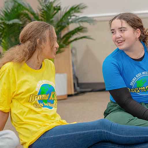 Acting-Academy-two-young-ladies-talking-on-floor Young ladies enjoying their Drama Kids class